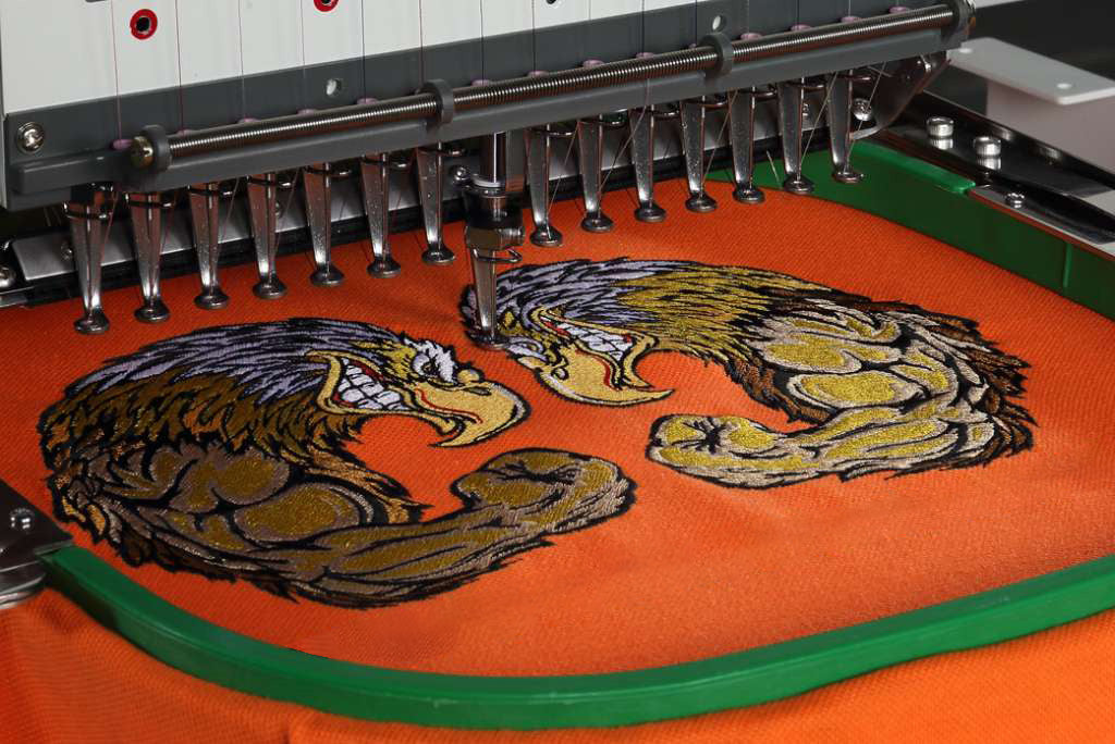 Custom embroidered logo on a orange sweatshirt by Print View