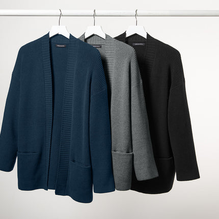 Catalog for three women's open cardigans in blue, gray, and black hanging on a rack 