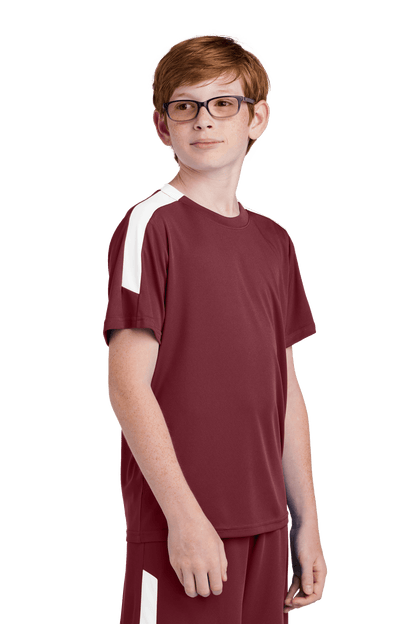 Maroon and white custom youth soccer jersey by Sport-Tek with space for name, number, and team logo, shown from side view.