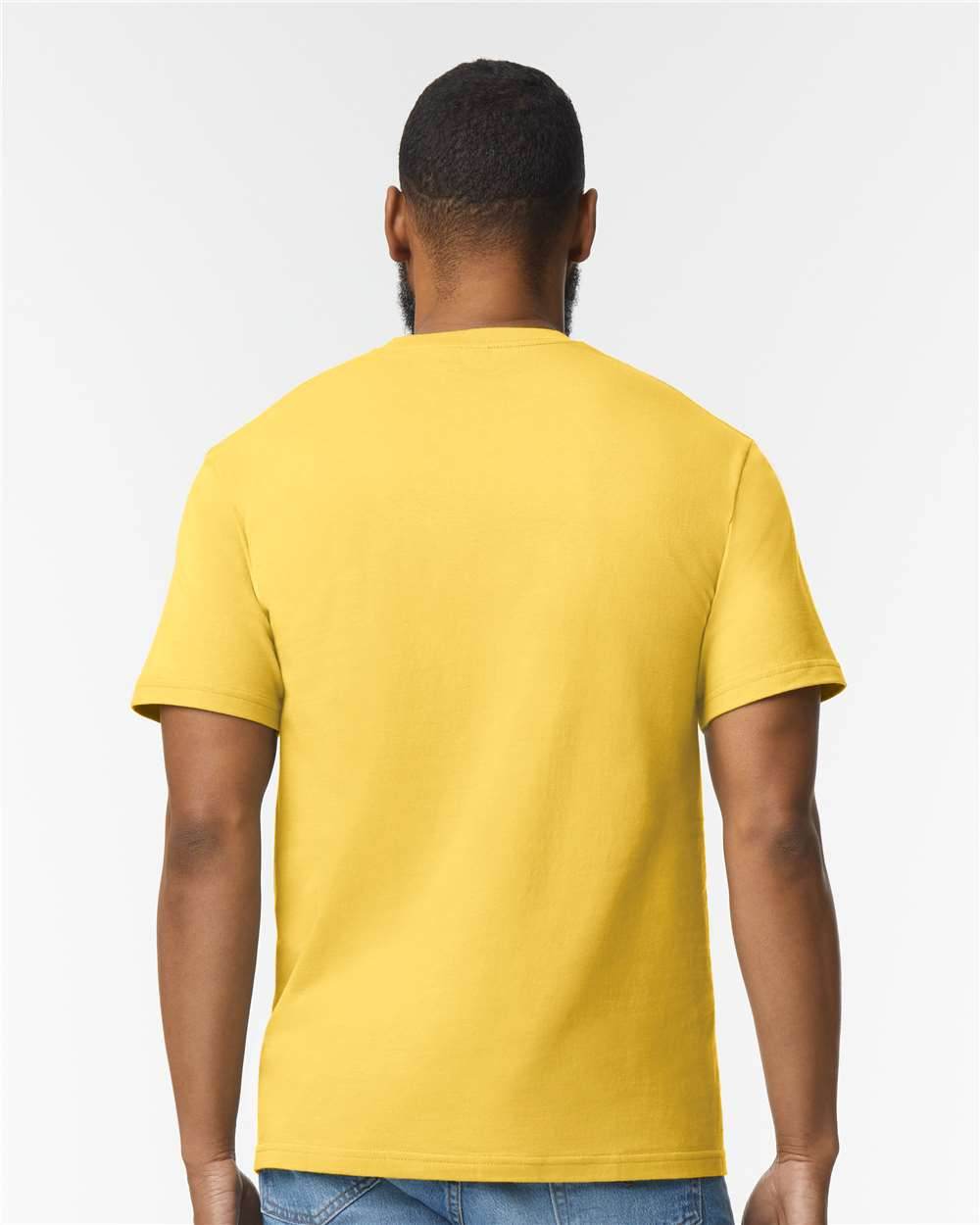 Gildan Softstyle midweight T-shirt in daisy pattern, back view on high-model, soft fashion style, printed fabric details visible.