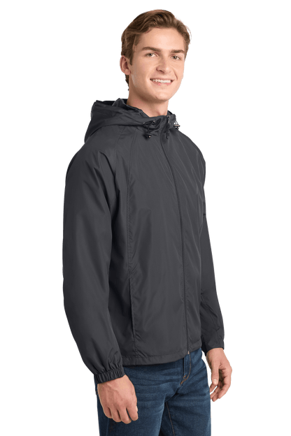 Sport-Tek hooded raglan windbreaker jacket in graphite, shown from side view, lightweight and sporty for active wear.