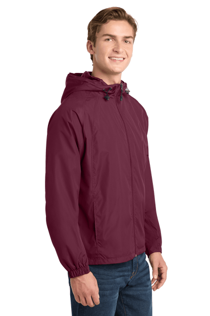 Sport-Tek hooded raglan windbreaker jacket in maroon, shown from the side with a lightweight, sporty design.