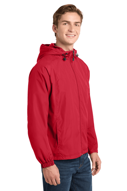 Sport-Tek hooded raglan windbreaker jacket in true red, shown from the side, lightweight and sporty outdoor outerwear.