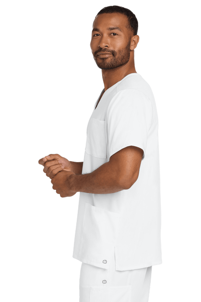Male nurse wearing white Wink Premiere Flex V-Neck scrub top, showing a plain and comfortable medical scrub shirt.