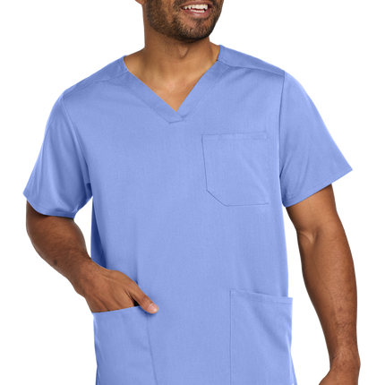 Male nurse wearing flex V-neck scrub top in light blue front
