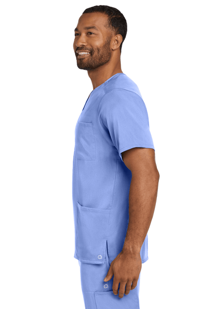 Male nurse wearing Wink Men's Premiere Flex V-Neck Scrub Top in light blue, showcasing the comfortable fit and professional style.
