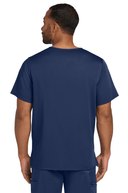 Navy blue Men's Premiere Flex V-Neck Scrub Top by Wink worn by male nurse, showing back view with printed design.