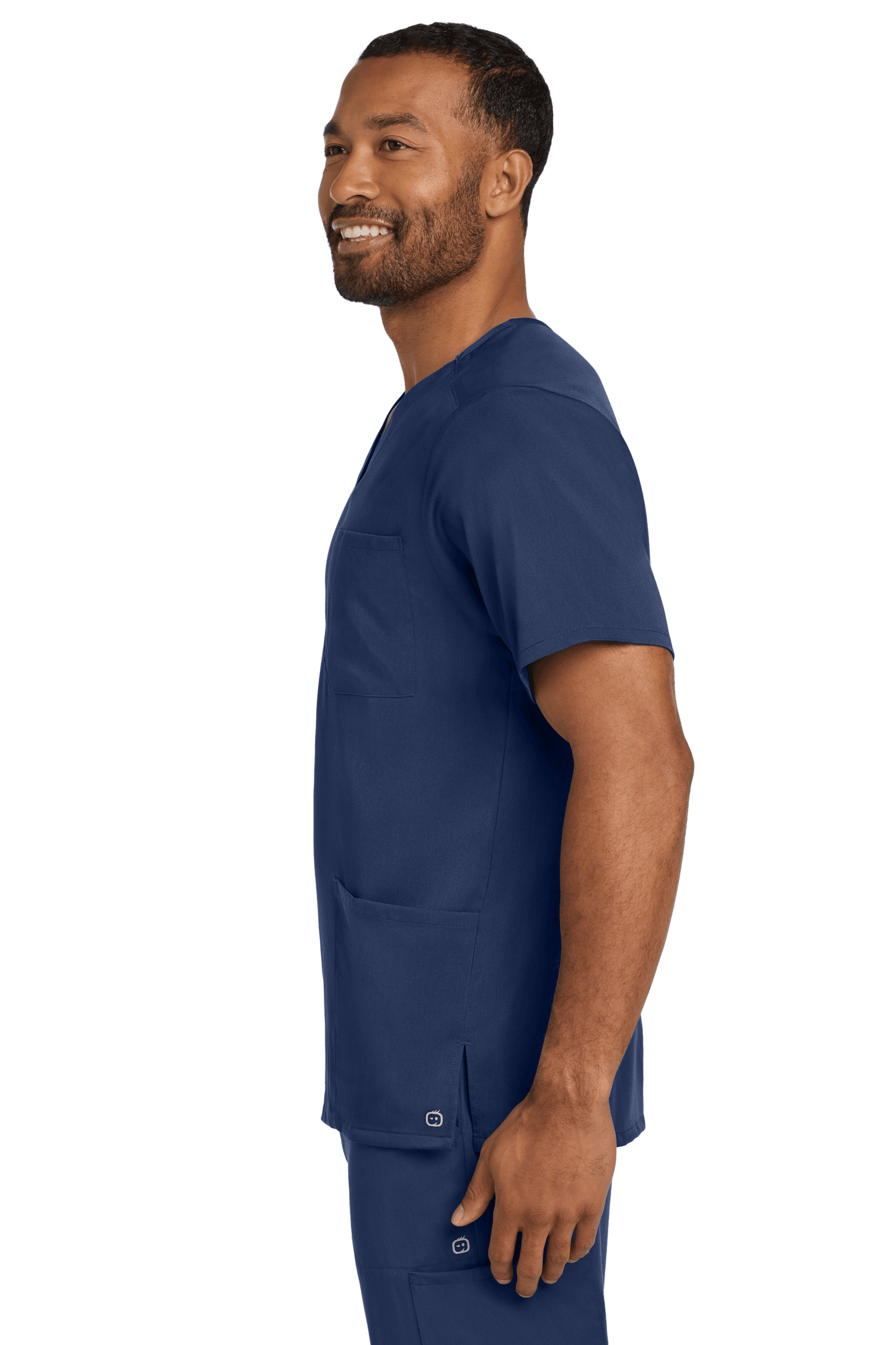 Navy blue men's Premiere Flex V-neck scrub top by Wink, worn by a nurse, featuring a comfortable fit and professional style.