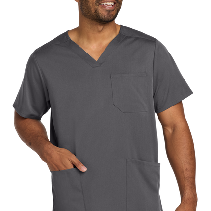 Male nurse wearing pewter grey flex V-neck scrub top front