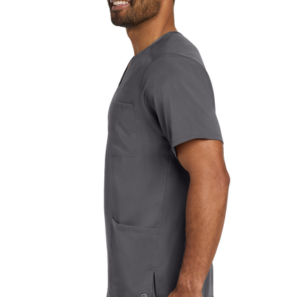 Male nurse wearing pewter grey flex V-neck scrub top side
