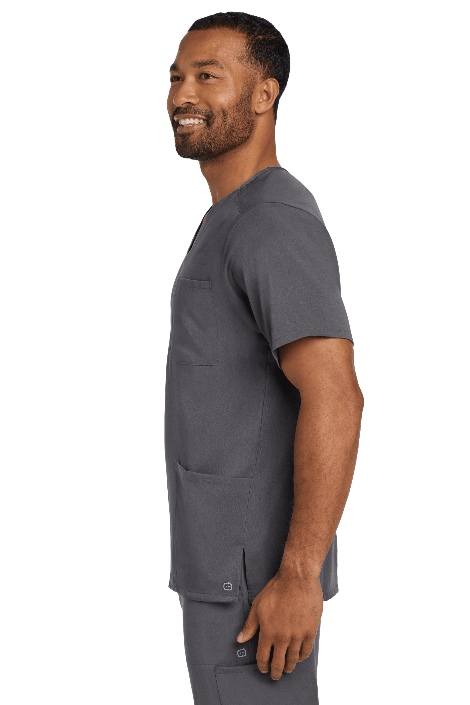 Male nurse wearing Wink Men's Premiere Flex V-Neck Scrub Top in pewter grey, showing the side view of the printed scrub top.