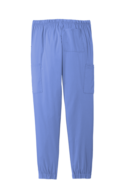 Light blue women's Wink Premiere Flex jogger nursing scrub pants with printed design, shown from the back view.
