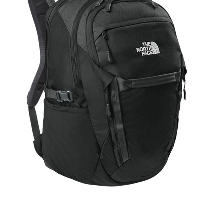 The North Face® 31L Royal Arch backpack in black, showing a side view with padded shoulder straps and front zip compartments.