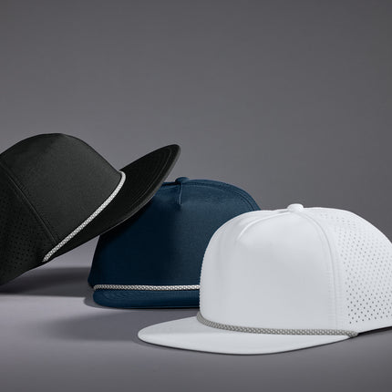 Three baseball caps in black, blue, and white 