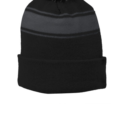 Black, grey, and white Sport-Tek® stripe pom pom beanie with a flat front, designed for warmth and casual style.