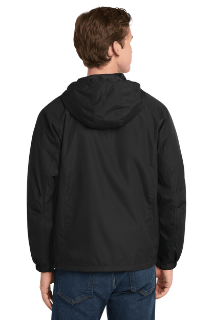Black Sport-Tek hooded raglan windbreaker jacket with front zipper and adjustable hood, worn by a model.