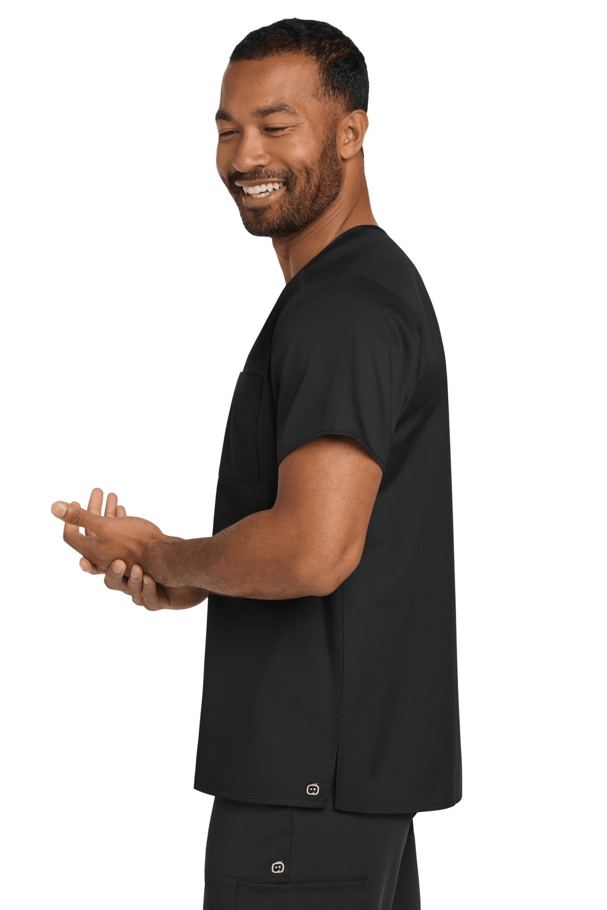 Black unisex Wink medical scrubs top with V-neck and flex chest pocket, shown from the side view.