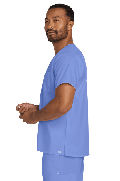 Light blue unisex medical scrub top with V-neck and flexible chest pocket, designed by Wink, shown from side view.
