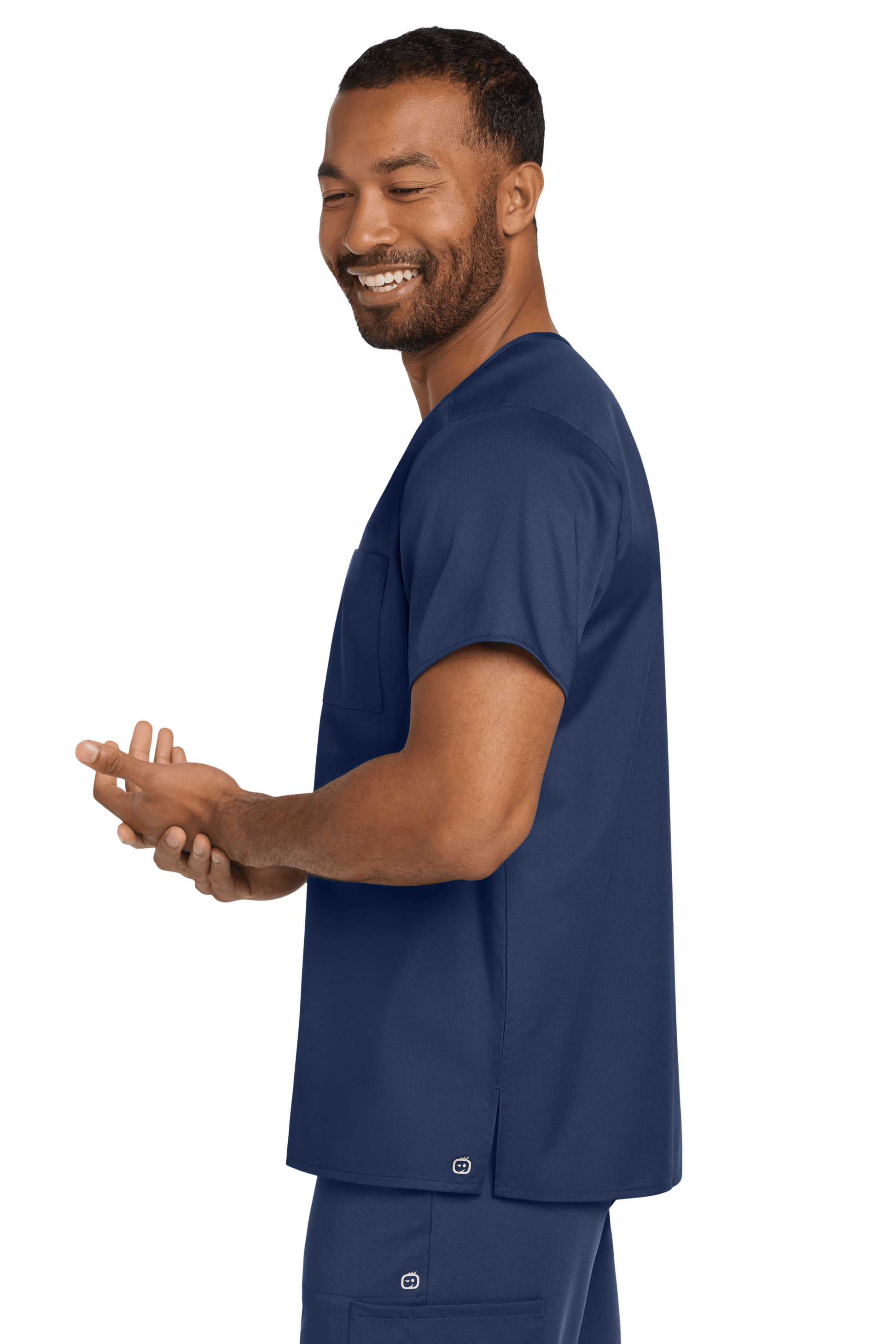 Navy unisex medical scrubs V-neck top with flex chest pocket, worn by a model side view, by Wink.