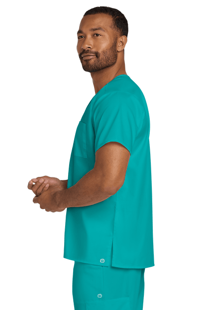 Unisex teal medical scrubs top by Wink with a V-neck and flex chest pocket, shown from the side view.