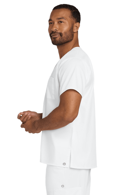 Unisex white medical scrubs top by Wink with a V-neck and flexible chest pocket, shown from a side view.