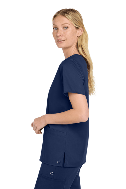Women’s Wink Medical WorkFlex™ mock wrap scrub top with navy print, shown from side view, designed for comfortable medical workwear.