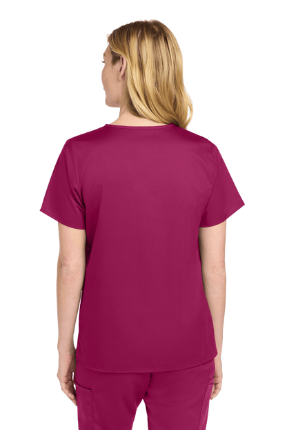 Wink Women's Medical WorkFlex™ mock wrap scrub top with printed design, shown from the back on a female model.