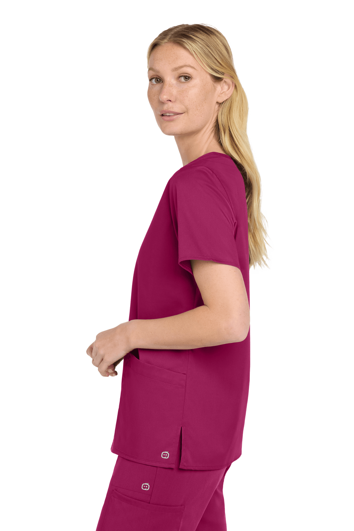 Wink Women's Medical WorkFlex™ mock wrap scrub top with colorful print, worn by a female model, side view showing fit and design.