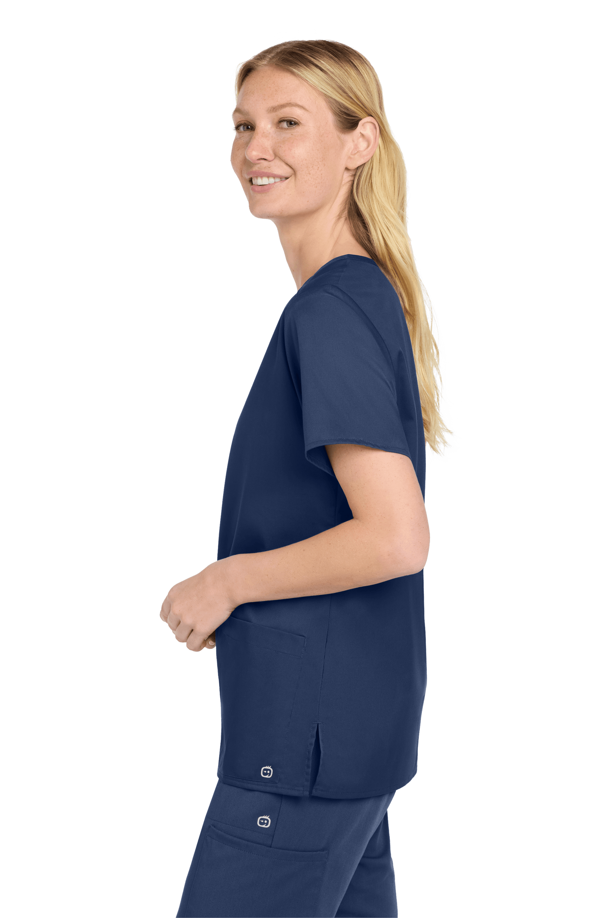 Women’s navy blue Wink medical scrub top with a flexible V-neck and printed design, shown from a side view.