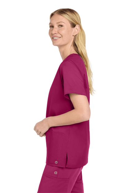 Women’s Wink medical scrub top with a flexible V-neck and printed design, shown from a side view.
