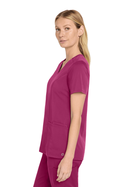 Women’s Wink Premiere Flex V-neck scrub top in wine color, shown from side view with print design.