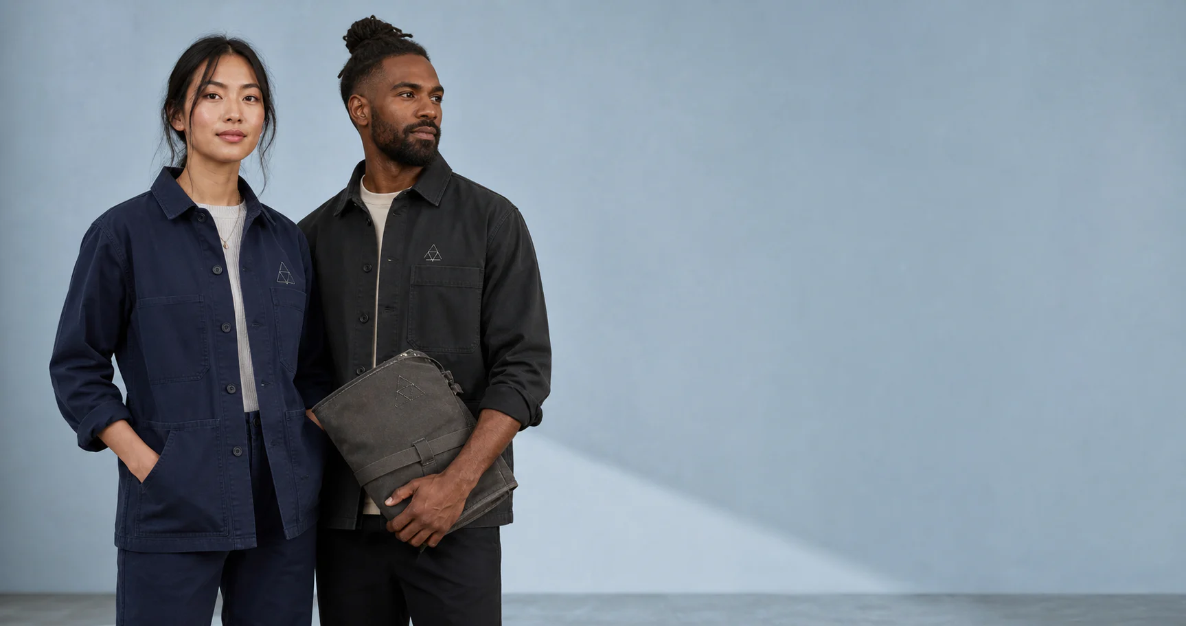 Two makers wearing coordinated embroidered workwear